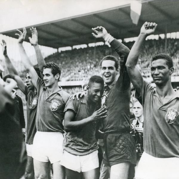 Brazil's seventeen-year-old Pele (Edson Arantes do Nascimento, center) weeps on the shoulder of goalkeeper Gylmar Dos Santos Neves (right) after Brazil's 5-2 victory over Sweden in the final of the soccer World Cup in Stockholm, Sweden, on June 29, 1958. Other players are unidentified (AP Photo)