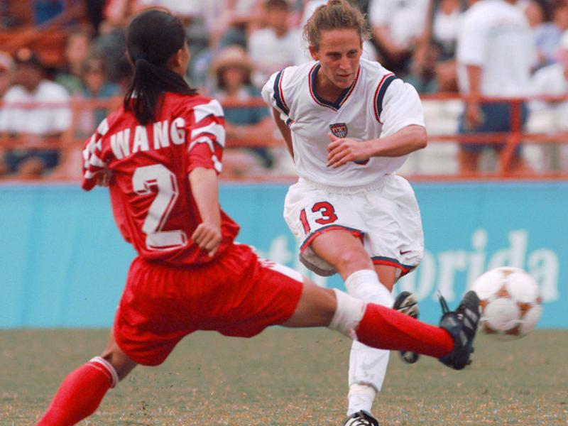 U.S. forward Kristine Lilly attempts to pass the ball during a 1996 Olympics women's soccer game against China.