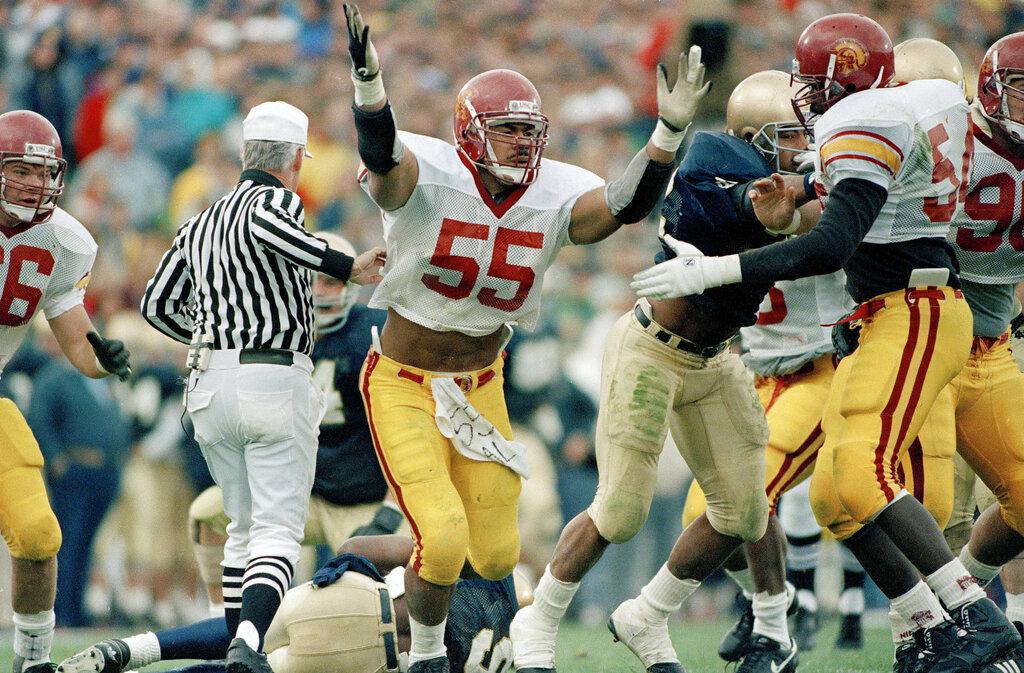 USC's Junior Seau (55), celebrates after sacking Notre Dame quarterback Tony Rice (9) during the first quarter of the game at South Bend, Ind., Oct. 21, 1989. (AP Photo/Rob Kozloff)